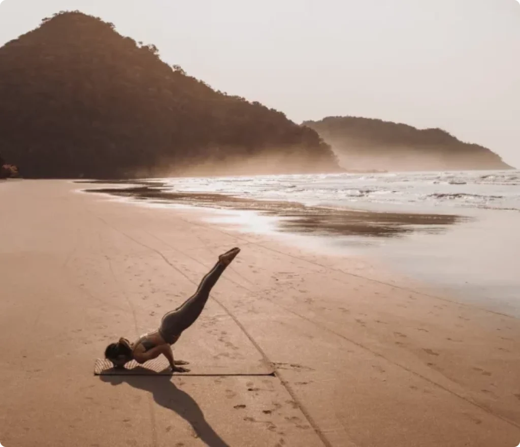 woman exercising on the beach
