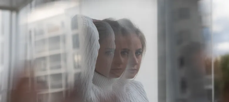 portrait-young-woman-seen-through-glass-window