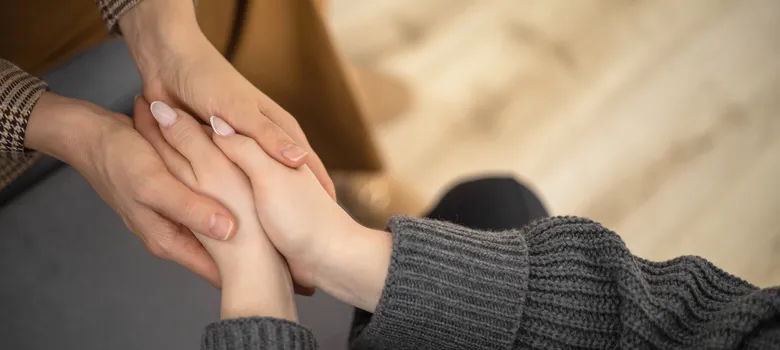 two-woman-holding-hands-each-other-concept-support-care-trust-help-sisterhood-top-view-closeup